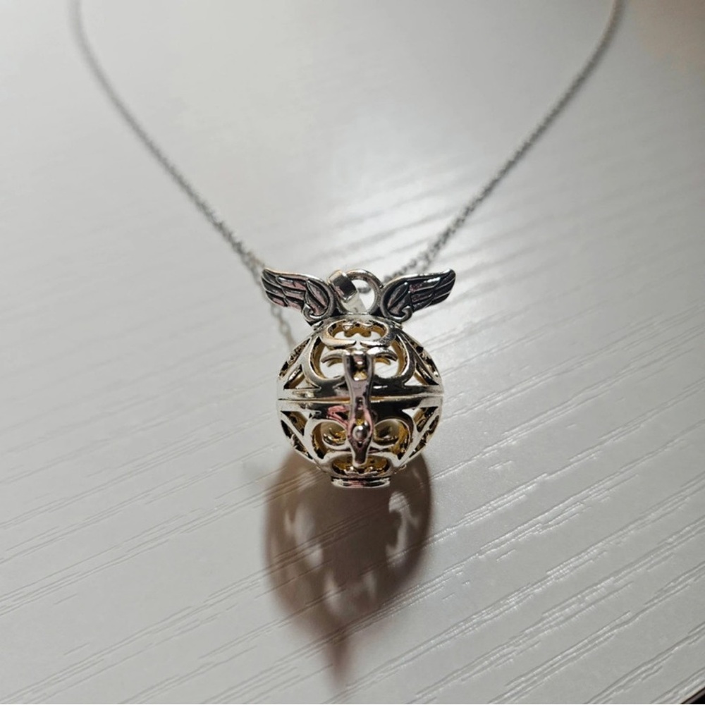 Elegant Winged Sphere Necklace in Silver and Gold